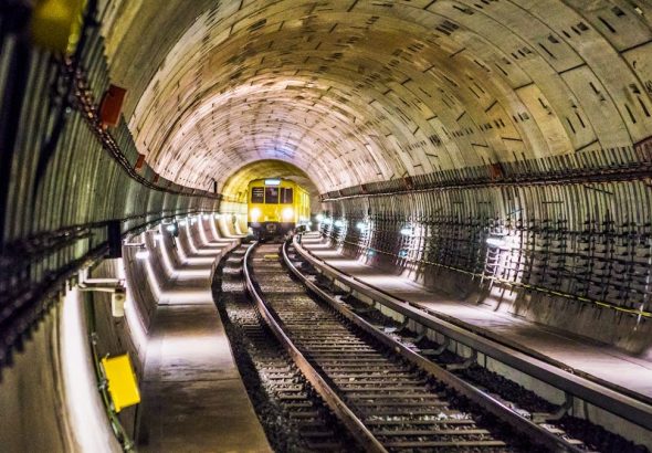 Dramatic view of a Berlin subway tunnel with train approaching, showcasing modern infrastructure.